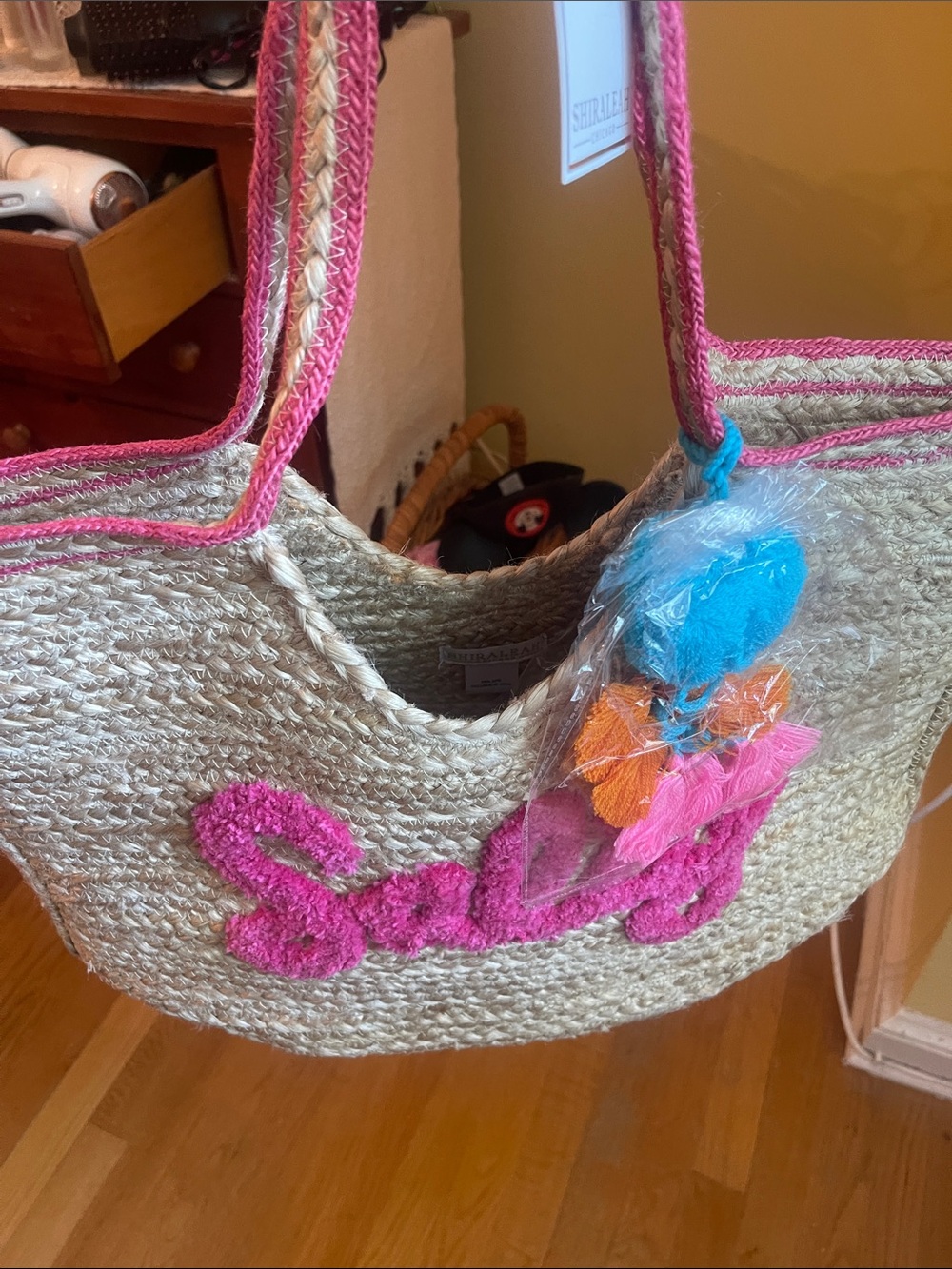 Shiraleah Natural Straw Tote with Pink Trim and Blue-Orange Pom Accents